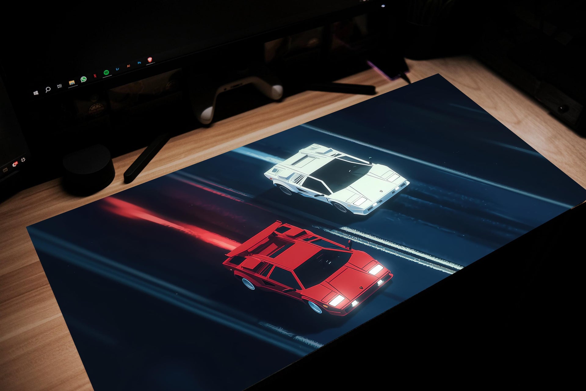 Car-themed desk mat with red and white car design on a dark surface.