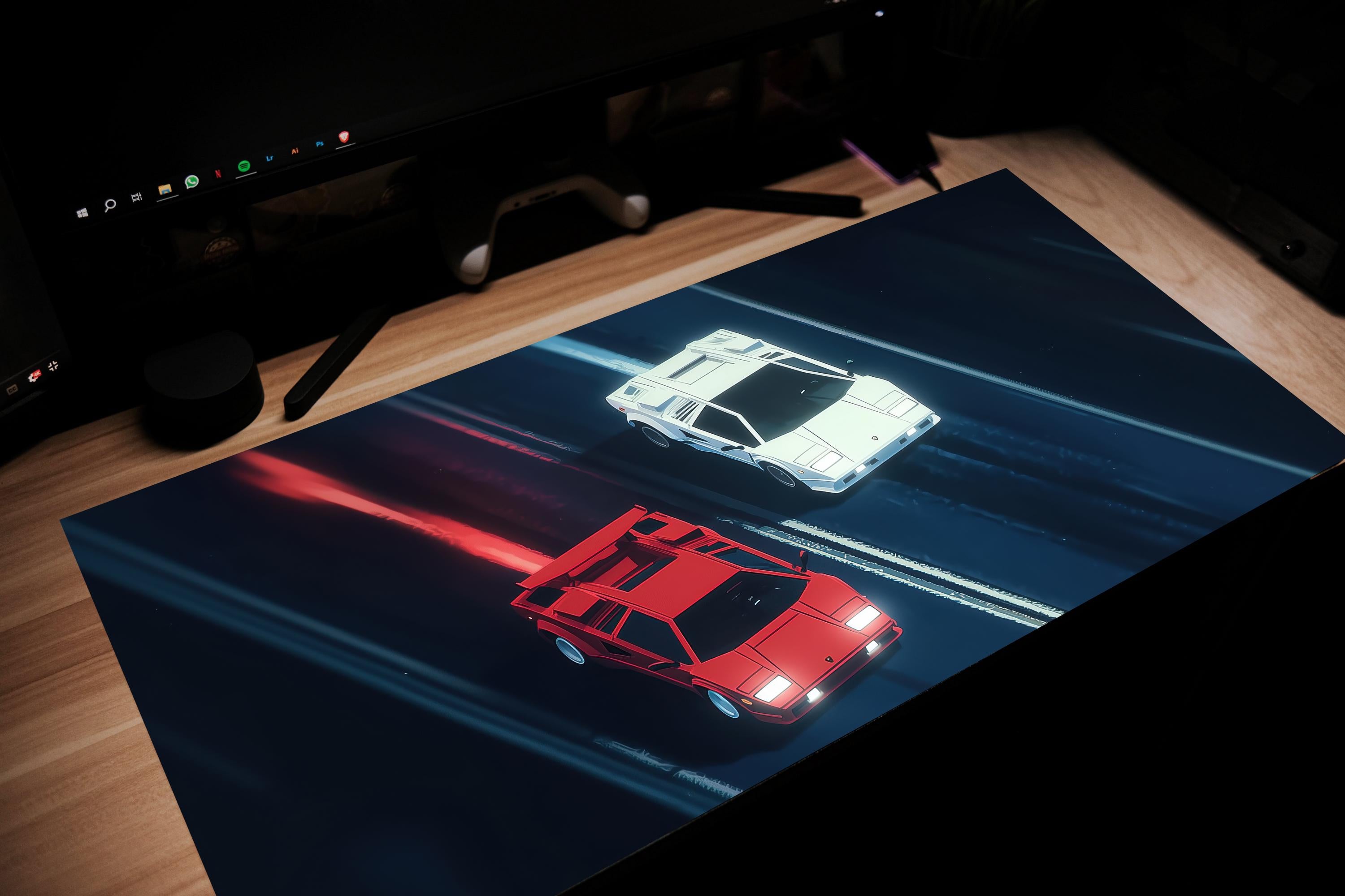 Car-themed desk mat with red and white car design on a dark surface.